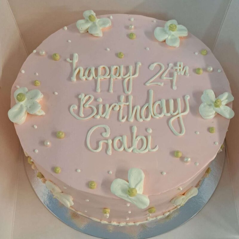 Pink cake with white flower