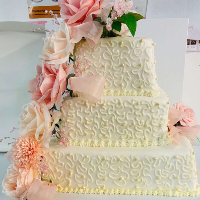 White Wedding cake with flower Go up